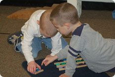 Children playing with colorful building blocks.